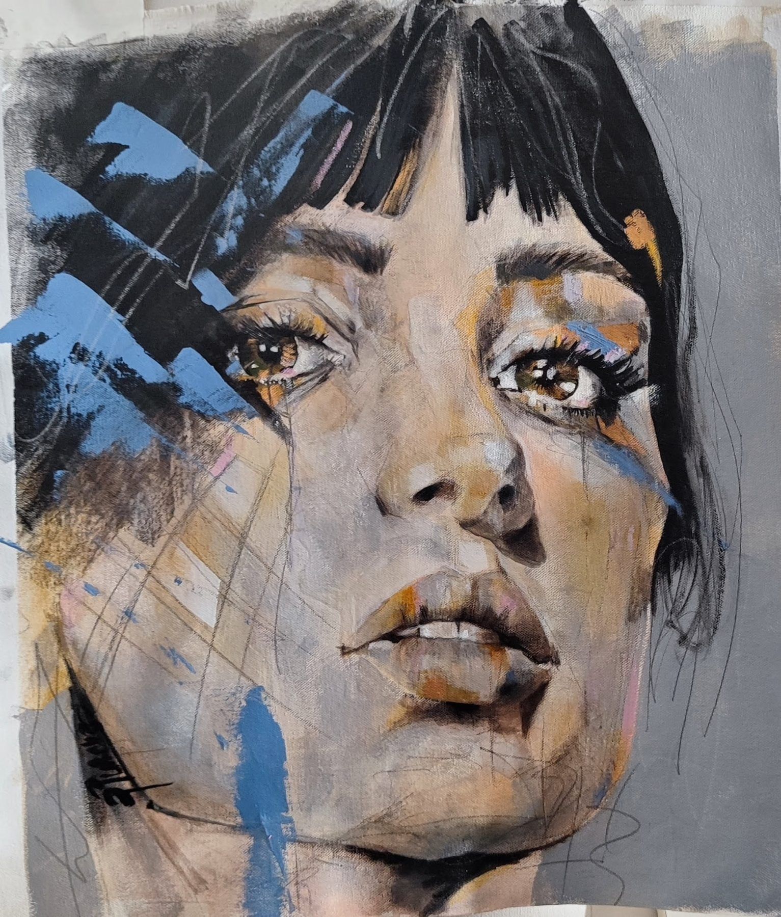 Bruma, contemporary figurative portrait by PilarchoArt: a woman's face with a dark fringe in grey, ochre and pale blue tones, with charcoal lines over a grey ground.